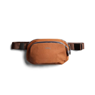 Bellroy Venture Hip Pack 1.5L in burnt orange with front zip pocket and adjustable belt strap