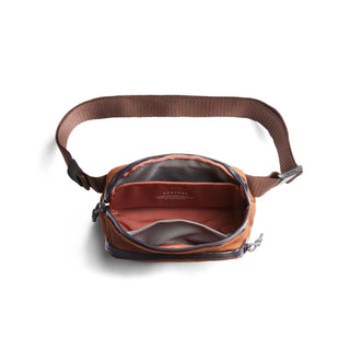 Bellroy Venture Hip Pack 1.5L open view showing organized interior pockets and rust brown recycled fabric