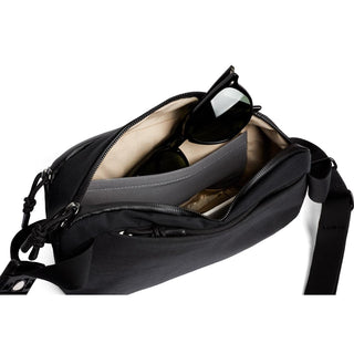Bellroy Venture Ready Sling 2.5L in black with beige interior and sunglasses inside pocket