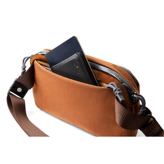 Bellroy Venture Ready Sling 2.5L in brown with secured zipper and adjustable shoulder strap details