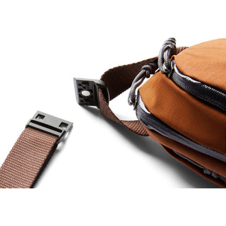 Bellroy Venture Ready Sling 2.5L in rust fabric with detachable buckle and adjustable strap detail