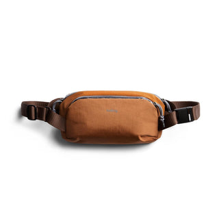 Bellroy Venture Ready Sling 2.5L in orange recycled nylon with brown adjustable strap and front zipper pocket