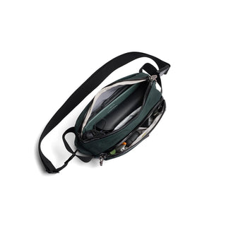 Bellroy Venture Ready Sling 2.5L in dark green with adjustable strap and multiple compartments open view