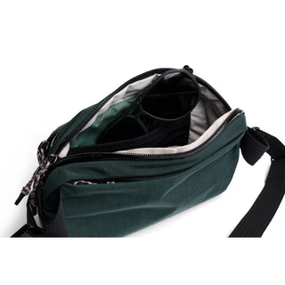 Bellroy Venture Ready Sling 2.5L showing open top view with green recycled fabric and interior compartments