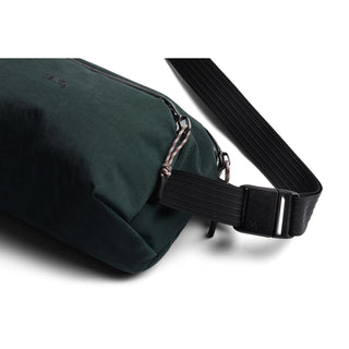Bellroy Venture Ready Sling 2.5L in dark green recycled fabric with adjustable black strap close-up