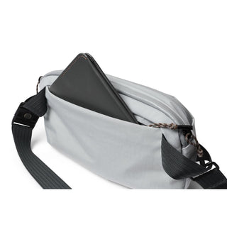 Bellroy Venture Ready Sling 2.5L in light gray with black strap and tablet partially inside pocket
