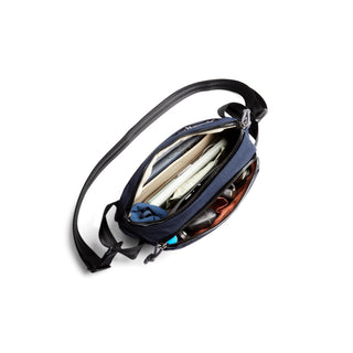 Bellroy Venture Ready Sling 2.5L in navy blue showing organized interior compartments and adjustable strap