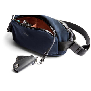 Bellroy Venture Ready Sling 2.5L navy crossbody bag with accessible front pocket and key fob attached