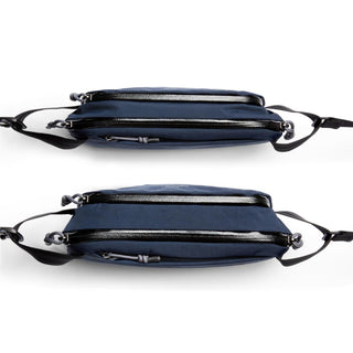 Bellroy Venture Ready Sling 2.5L in dark blue recycled fabric showing dual zippered compartments and adjustable strap