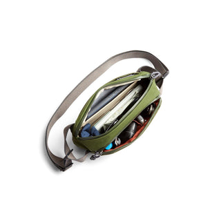 Bellroy Venture Ready Sling 2.5L in olive green showing organized contents and adjustable strap
