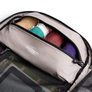 Bellroy Lite Travel Pack 30L open compartment showing organized packed clothing and mesh storage pocket