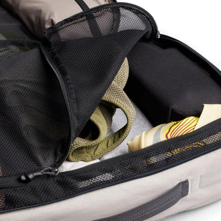 Bellroy Lite Travel Pack 30L open showing mesh compartment and organized packed clothing inside backpack