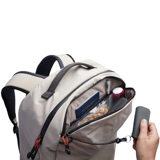 Bellroy Lite Travel Pack 30L beige backpack with front pocket holding travel essentials and key leash