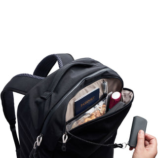 Bellroy Lite Travel Pack 30L in black showing organized front pocket with passport and accessories