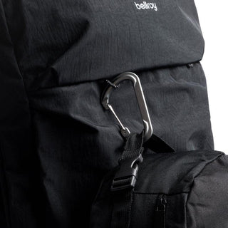 Bellroy Lite Travel Pack 30L in black recycled nylon with silver carabiner clipped to front strap