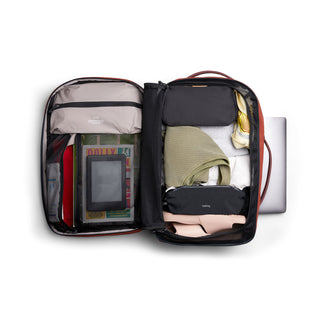 Bellroy Lite Travel Pack 30L open black backpack showing organized packed clothes and accessories inside