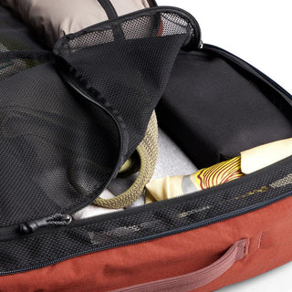 Bellroy Lite Travel Pack 30L open showing black mesh organizer pocket and packed travel essentials inside