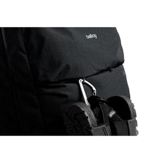 Bellroy Lite Travel Pack 38L black fabric backpack with carabiner clip holding hiking shoes