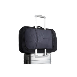 Bellroy Lite Travel Pack 38L in black fabric attached to silver suitcase handle with padded back panel visible