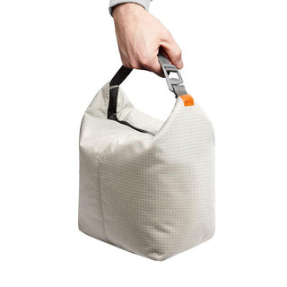 Bellroy Lite Cooler Caddy 10L in light gray with textured fabric and black handle held by hand