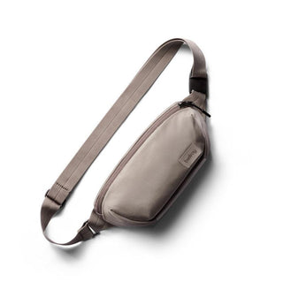 Bellroy Laneway Belt Bag in taupe with smooth recycled nylon fabric and adjustable strap displayed flat