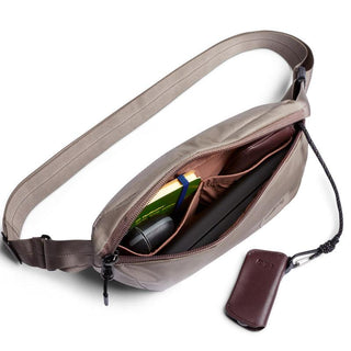 Bellroy Laneway Belt Bag in taupe showing organized interior with small essentials and key pouch attached