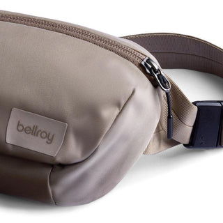 Bellroy Laneway Belt Bag in beige recycled nylon with zipper and adjustable strap buckle close-up