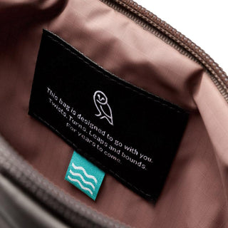 Bellroy Laneway Belt Bag interior showing black label with white text and logo on pink fabric lining