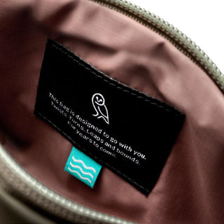 Interior label detail of Bellroy Laneway Belt Bag featuring durable recycled fabric lining and tag design
