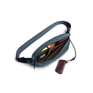 Bellroy Laneway Belt Bag in blue showing organized interior with compartments and detachable leather key holder
