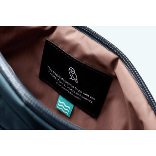 Bellroy Laneway Belt Bag interior label showing recycled fabric details and light brown lining close-up