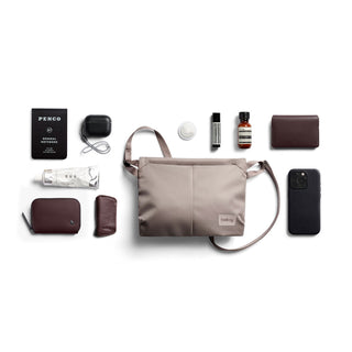Bellroy Laneway Sacoche in light taupe with sleek recycled fabric and front pockets shown with accessories