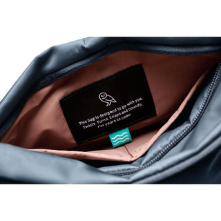 Bellroy Laneway Sacoche showing soft beige interior lining and a motivational fabric label inside the navy bag