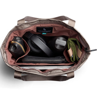 Bellroy Laneway Totepack opened showing organized compartments with tech and accessories inside beige fabric lining