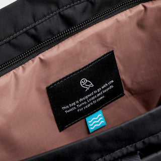 Bellroy Laneway Totepack interior with pink lining and black label featuring care and durability message