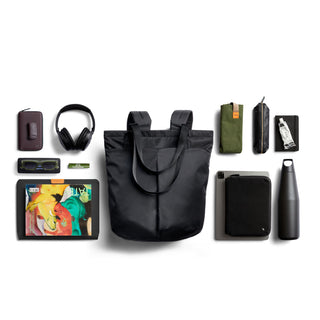 Bellroy Laneway Totepack in black nylon with top handles and shoulder straps, shown with everyday carry items