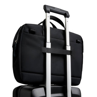 Bellroy Via Work Bag (Tech Briefcase) in black fabric attached to suitcase handle slot back view