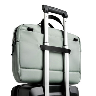 Bellroy Via Work Bag (Tech Briefcase) in soft green fabric secured on suitcase handle strap