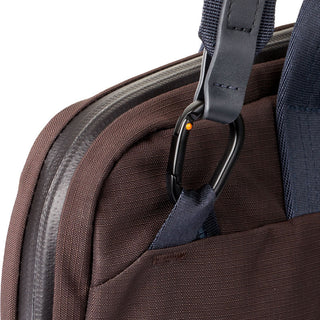 Close-up of the Bellroy Tokyo Laptop Bag 14" showing dark fabric texture and black metal carabiner clip
