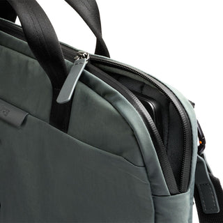 Bellroy Tokyo Laptop Bag 14" in muted green with black handles and partially open zipper showing laptop compartment