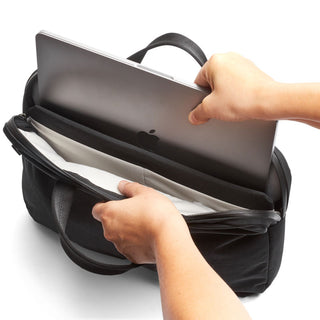 Bellroy Tokyo Laptop Bag 14" in black fabric with padded laptop compartment being opened by hands