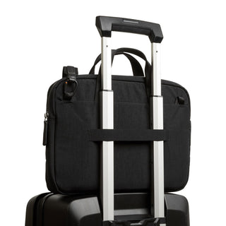 Bellroy Tokyo Laptop Bag 14" in black, showing rear trolley sleeve attachment on suitcase handle
