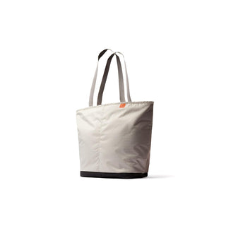 Bellroy Lite Cooler Tote 16L in beige with black base and sturdy dual handles made from recycled materials