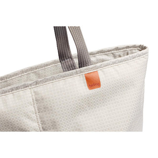 Bellroy Lite Cooler Tote 16L in light beige with textured fabric and sturdy grey handles close-up view