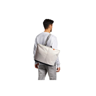 Bellroy Lite Cooler Tote 16L in light beige recycled fabric carried over shoulder by man