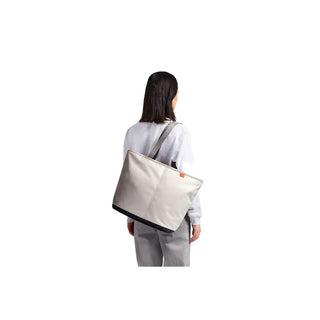 Bellroy Lite Cooler Tote 16L in light gray with recycled fabric, worn on shoulder from back view