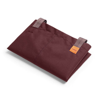 Folded Bellroy Market Tote in dark burgundy recycled nylon fabric with tan carrying handles and label
