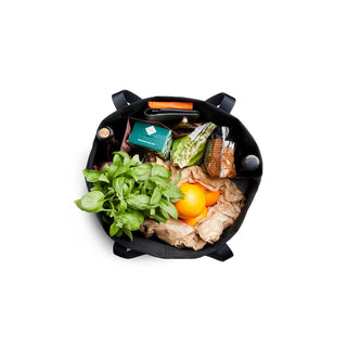 Bellroy Market Tote filled with groceries showing black recycled nylon fabric and sturdy handles