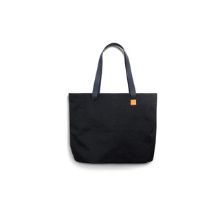 Bellroy Market Tote in black recycled nylon with long handles and a small orange logo patch