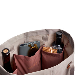 Bellroy Market Tote showing organized interior pockets holding bottles, wallet, and packaged snacks